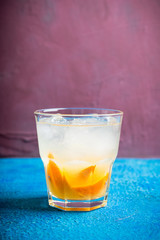Old fashioned beverage with orange slices on rustic background. Selective focus. Shallow depth of field.