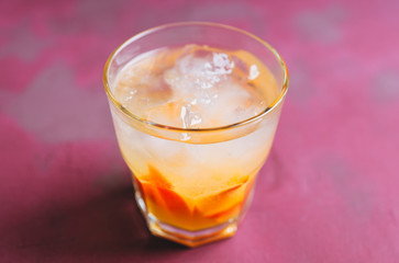 Old fashioned beverage with orange slices on rustic background. Selective focus. Shallow depth of field.