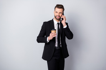 Portrait of positive agent man have work relax time hold take-out coffee beverage mug speak on cell phone colleagues family friends wear black pants blazer jacket isolated grey color background