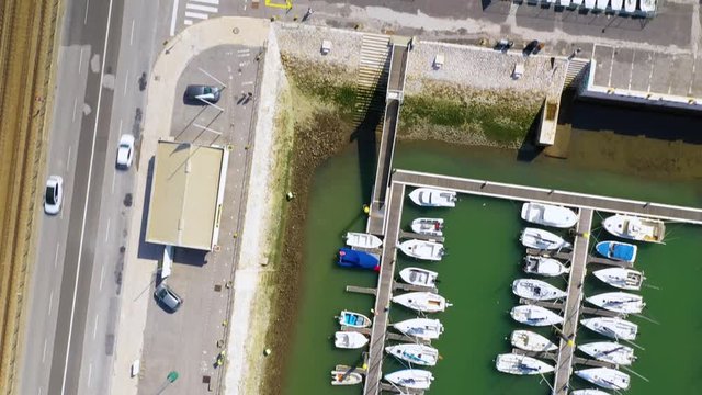 Aerial, top down, drone shot over boats on the Doca de Belem harbor, sunny day, in Lisbon, Portugal