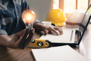 Hand of male holding a light bulb and copy space for accounting, ideas and creative concept.