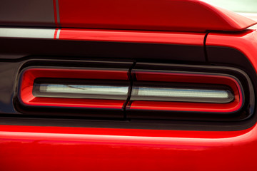 Car headlights. Luxury Headlights. Part of a red car