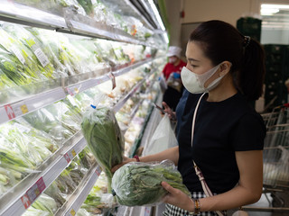 Asian woman wearing protect face mask and rubber gloves shopping food