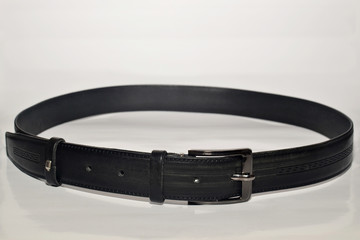Fashionable black trouser belt on a white background