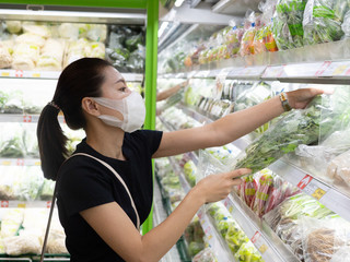 Asian woman wearing protect face mask and rubber gloves shopping food
