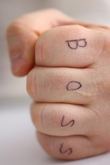 Male clenched fist in suit at office closeup