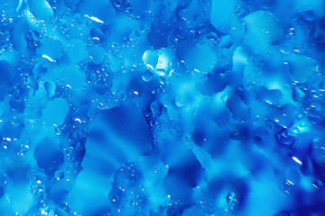 water drops on a blue background. Abstract blue background. Water drops on glass.