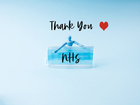 Thank You Card For NHS Staff, Doctors And Nurses Who Save Lives Every Day With Marionette Holding Face Mask On Blue Background