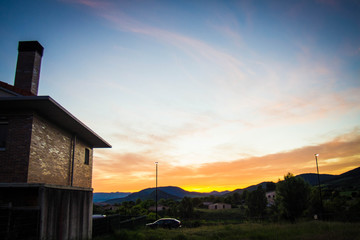 house and colorful sunset sky in spring.