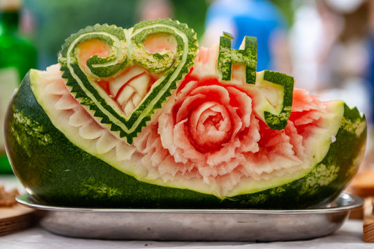 Carved watermelon floral decoration with heart and letters. The art of fruits and vegetable carving. Sculpture fruits and vegetable in to the beautiful flowers.