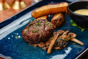 Beef Filet, steak with roast vegetables and mushrooms on a white plate, top view, Beef grilled steak with set of grilled vegetables close up

