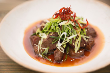 Beef Stir Fry with spring onion and saffron, close up, Grilled beef with onion and chives stir-fry
