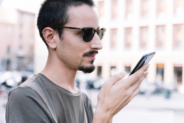 Man using a mobile phone in the middle of the street