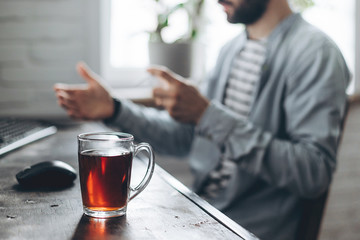 quarantine due coronavirus pandemic. stay at home. business man working from home, wear a protective mask. Work from home with disinfectant gel. remote work, learning due to the epidemic COVID-19.