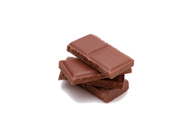 Pieces of chocolate on a white background, isolate. Broken chocolate bar