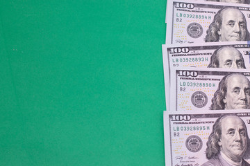 Dollar bills on a green background. Place for text, copy space