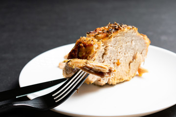 A large piece of baked meat on a white plate