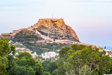 Panoramic view of Alicante, Valencian Community, Spain. In the foreground the Castle of Santa Barbara, the Postiguet beach and the port in the background with the city on its shore 
