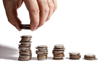 put coin in stack of coins. growing and save money concept,