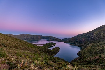 Fototapeta na wymiar Beautiful panoramic view of Lagoa do Fogo, Lake of Fire, in Sao Miguel Island, Azores, Portugal. Night Fall with Purple Sky and Birds