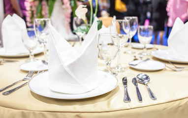 Close up white napkins folded on plates