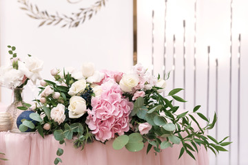 Original wedding floristics closeup. The wedding flower bouquet is supplemented with rose hortensia, roses and greenery. Floral background