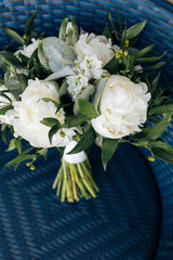 Wedding bouquet of flowers and greenery with white ribbon
