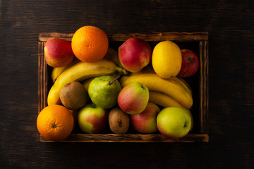 Set of fresh fruits in a wooden box. View from above.