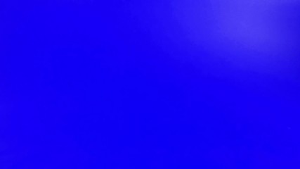 Pair of dices rolling forward to the camera on blue screen in slow motion