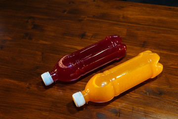 plastic bottles with soft drinks, mors and orange juice. red and yellow © kapralov