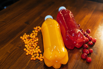 plastic bottles with soft drinks, mors and orange juice. red and yellow © kapralov
