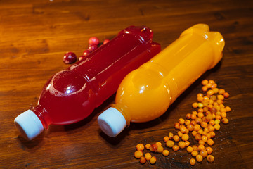 plastic bottles with soft drinks, mors and orange juice. red and yellow © kapralov