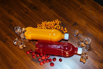 plastic bottles with soft drinks, mors and orange juice. red and yellow © kapralov