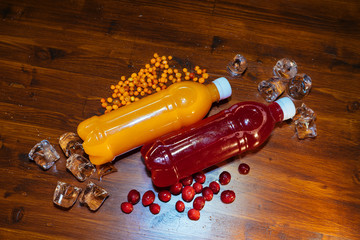 plastic bottles with soft drinks, mors and orange juice. red and yellow © kapralov