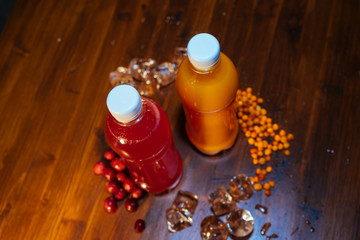 plastic bottles with soft drinks, mors and orange juice. red and yellow © kapralov