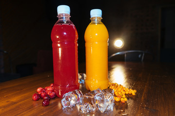 plastic bottles with soft drinks, mors and orange juice. red and yellow © kapralov