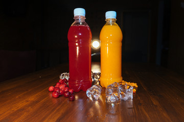 plastic bottles with soft drinks, mors and orange juice. red and yellow © kapralov