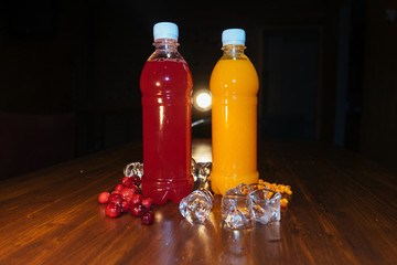 plastic bottles with soft drinks, mors and orange juice. red and yellow © kapralov