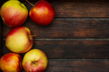 Several fresh apples in a wooden crate. View from above.