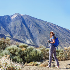 Naklejka na ściany i meble Young tourist woman near the Teide volcano