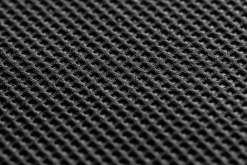 Black symmetrical synthetic fiber texture. Wattled black fabric texture. Close up. 