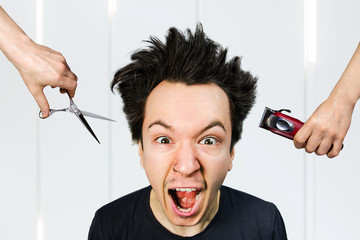 long hair freak crazy man hold scissors and trimmer and guy want cut his hair at home. Concept for...