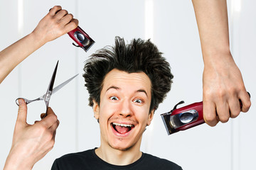 long hair freak crazy man hold scissors and trimmer and guy want cut his hair at home. Concept for...
