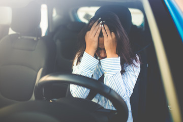 Cropped shot of a young woman looking stressed-out while sitting in her car. Stressed woman driver....