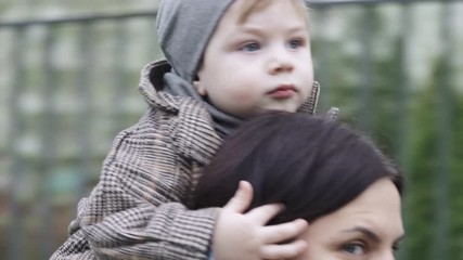 Boy child in a coat on mom
