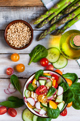 Concept of healthy food, clean eating, dieting. Colorful fresh vegetable salad in a bowl. Easy to cook, perfect summer light meal. Wooden background flat lay top view