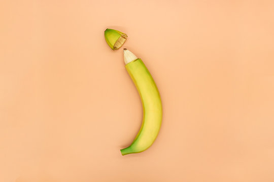 Concept of male circumcision, banana with the tip of the peel cut off