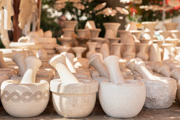 Fototapeta na wymiar A souvenir shop in Pucisca with it’s famous handmade limestone goods. Close up of mortar and pestles designed and crafted in different sizes and textures. For sale at a small market place
