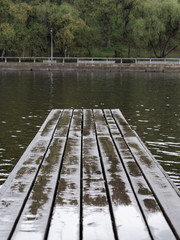 Wooden pier after rain and river water