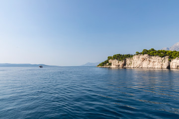 Makarska in Dalmatia, Croatia. View from the sea on a sunny day in the summer and a blue sky. A place famous for it&rsquo;s beaches and the peninsula. Holiday destination, Mediterranean coast